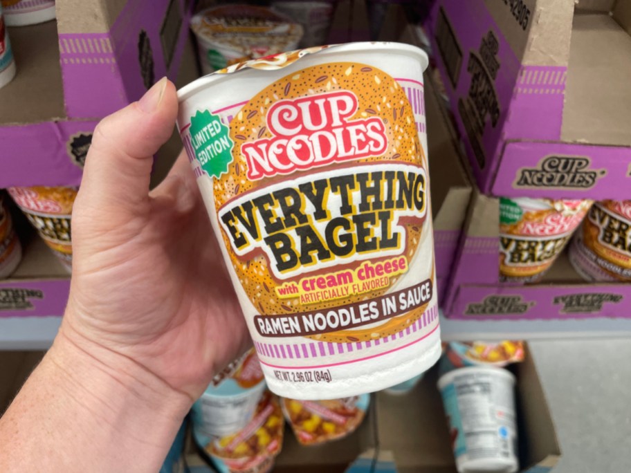 hand holding cup noodle everything bagel flavor in store