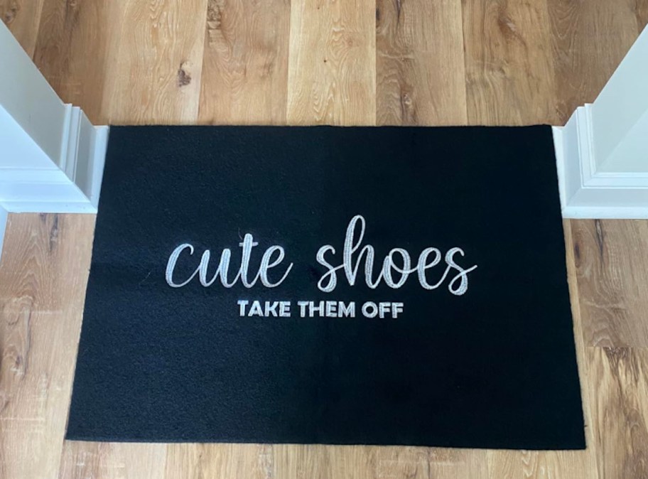 black cute shoes take them off mat on wood floor