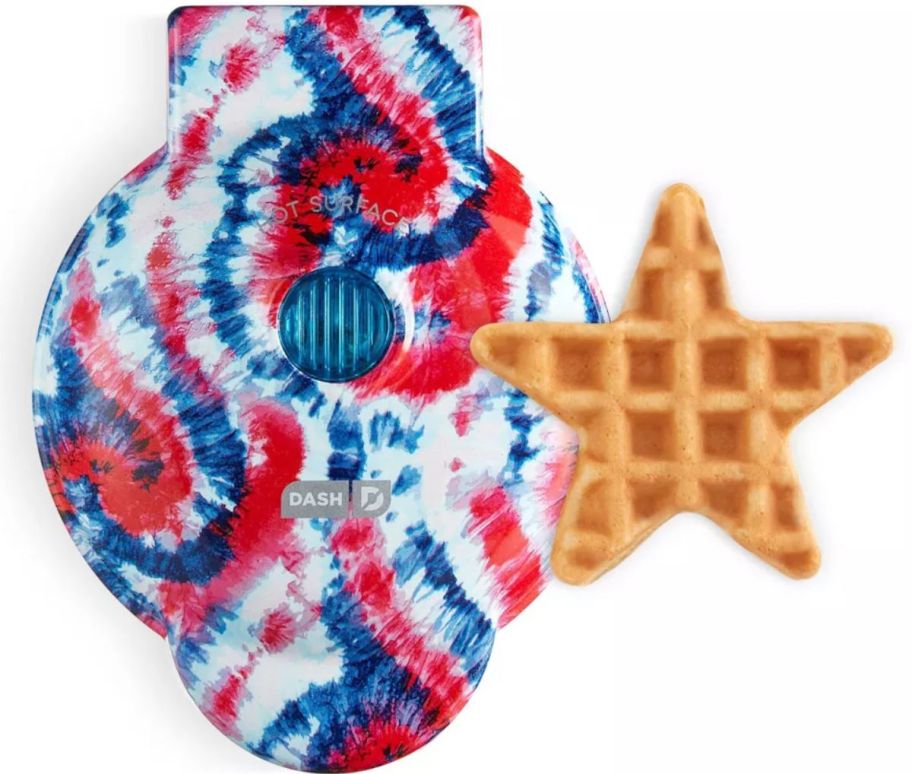 a red white and blue tie dye colored mini waffle maker shown with a star shaped waffle