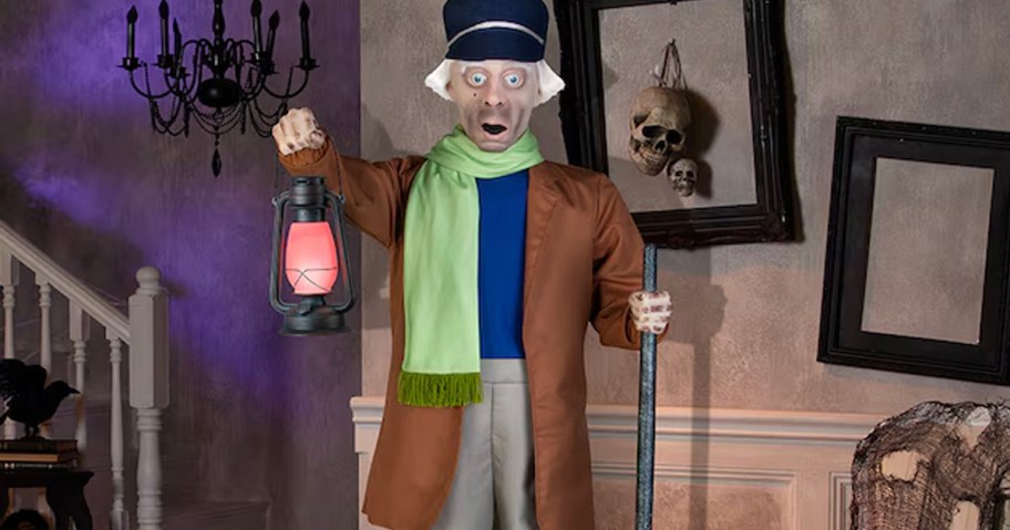 caretaker animatronic holding lantern in haunted house 