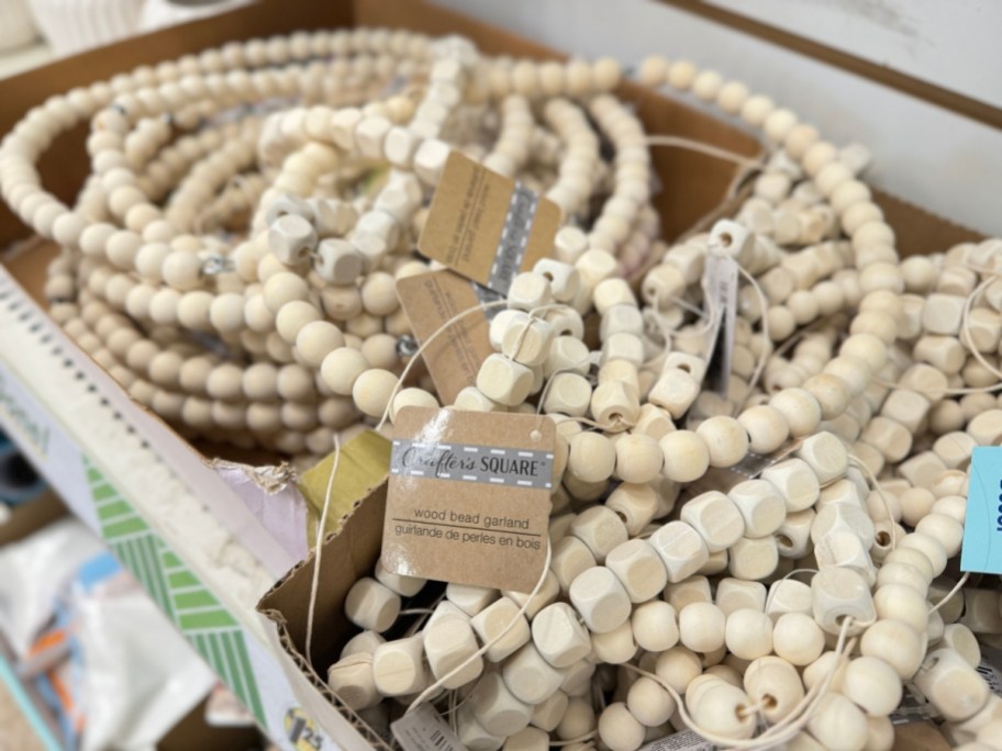 wood bead garland in boxes on store shelf