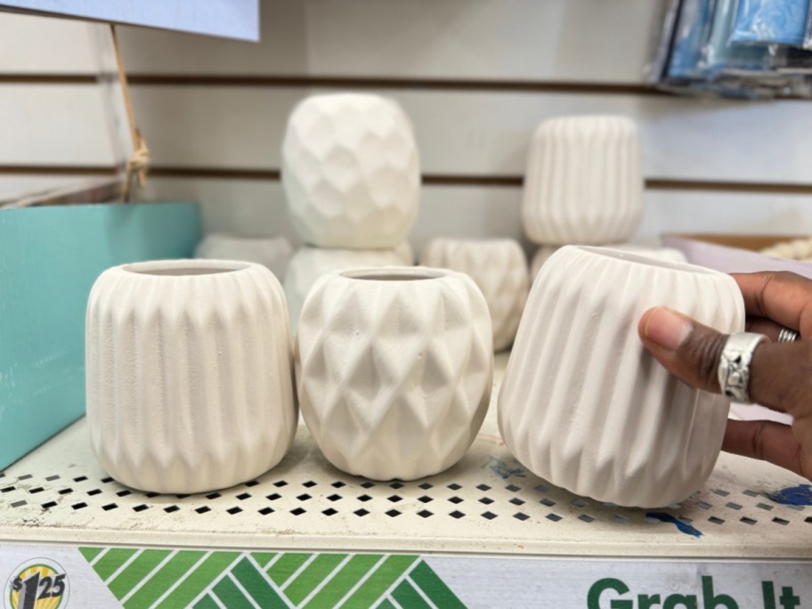 cream color candle holders with geometric patterns