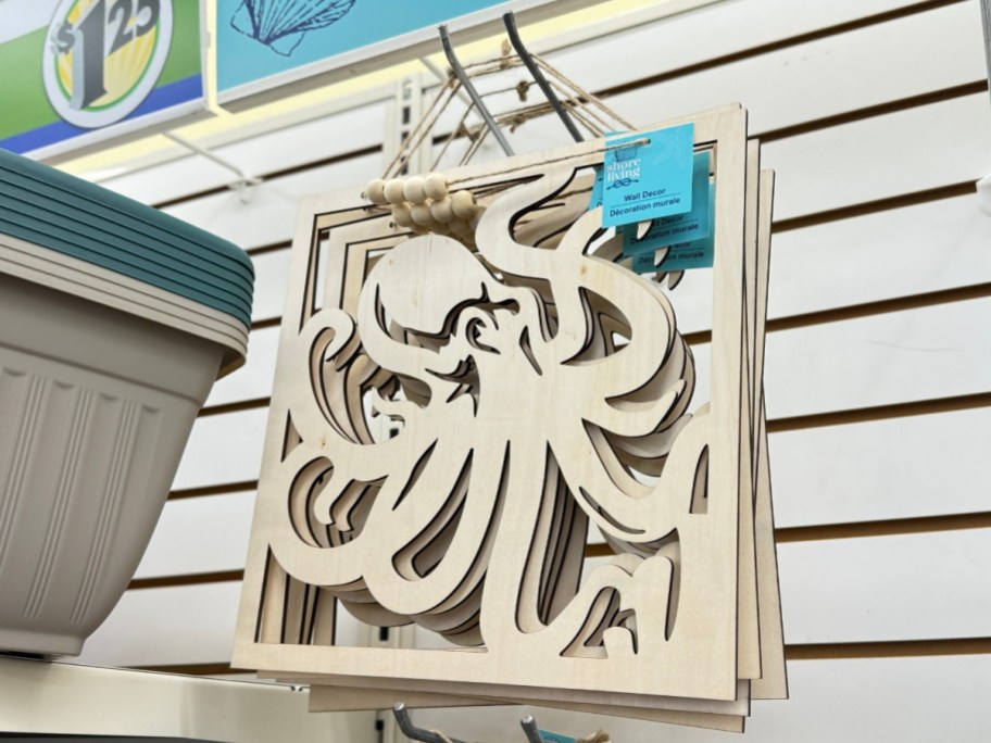 wooden octopus sign hanging on wall display