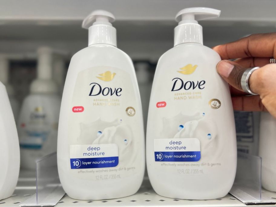 two bottles of dove hand soap on shelf