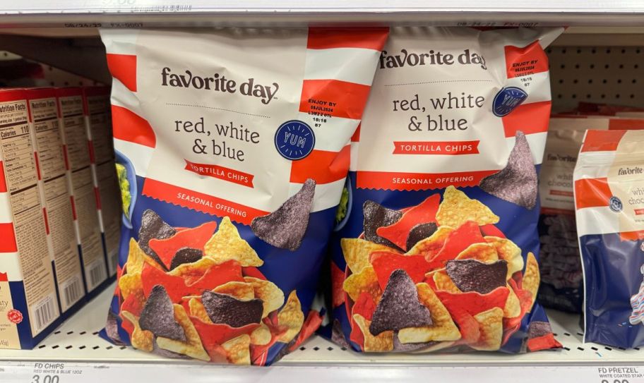 two bags of red white and blue tortilla chips on a store shelf