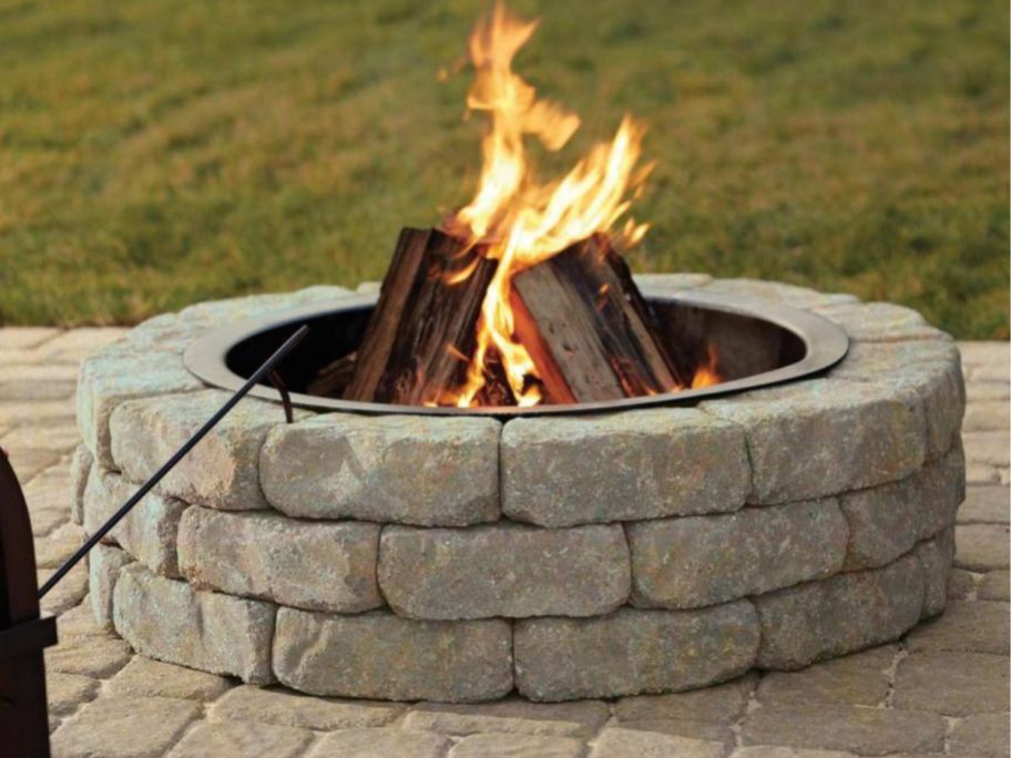 fire in fire pit made from stone wall blocks