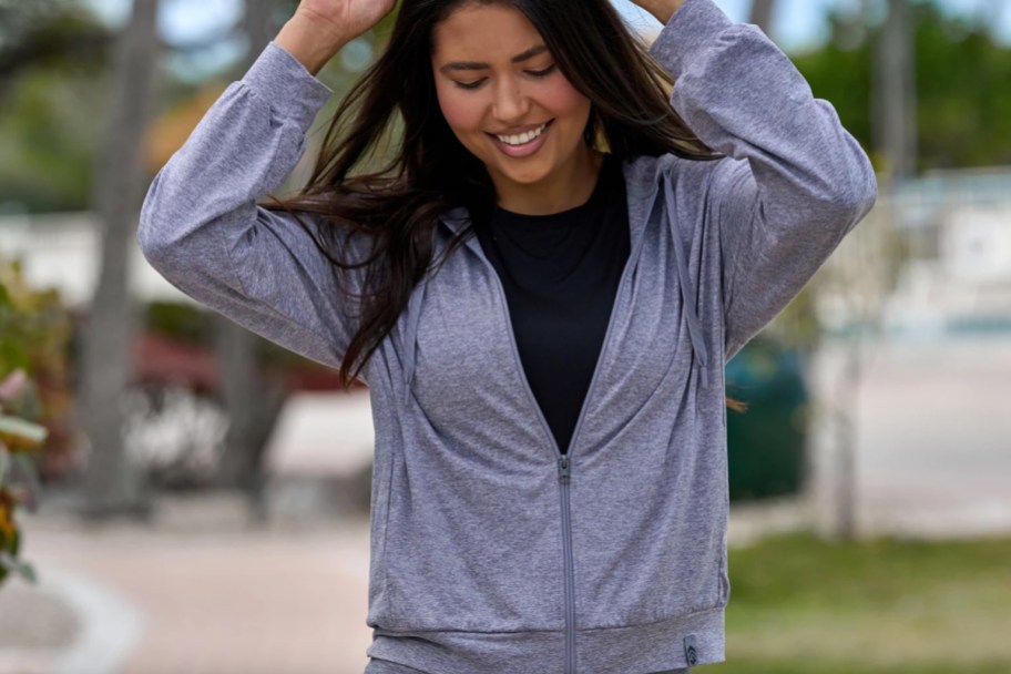 woman in grey zip pullover
