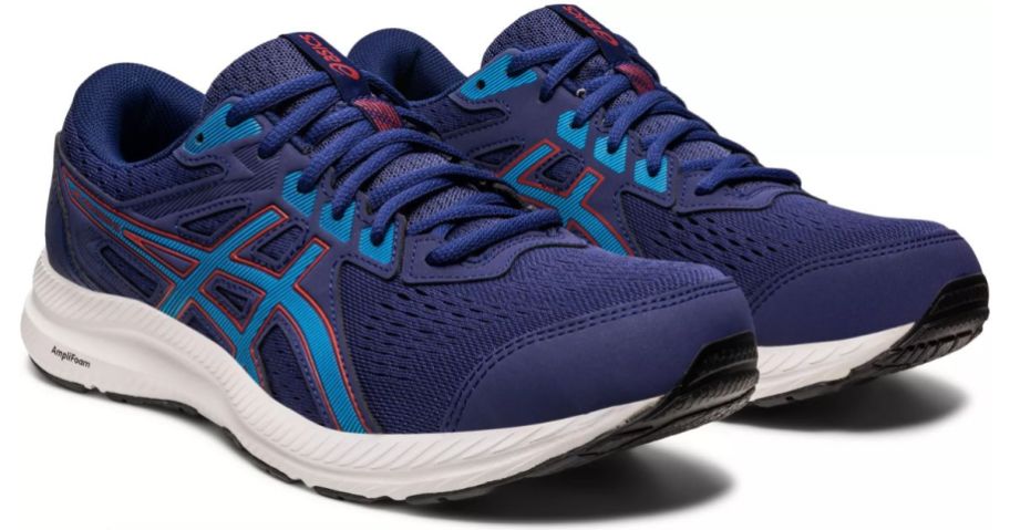 a pair of navy blue mens running shoes with bright blue accents
