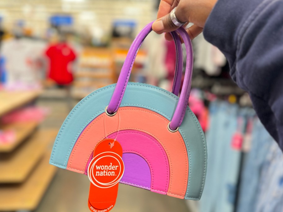 hand holding wonder nation rainbow bag