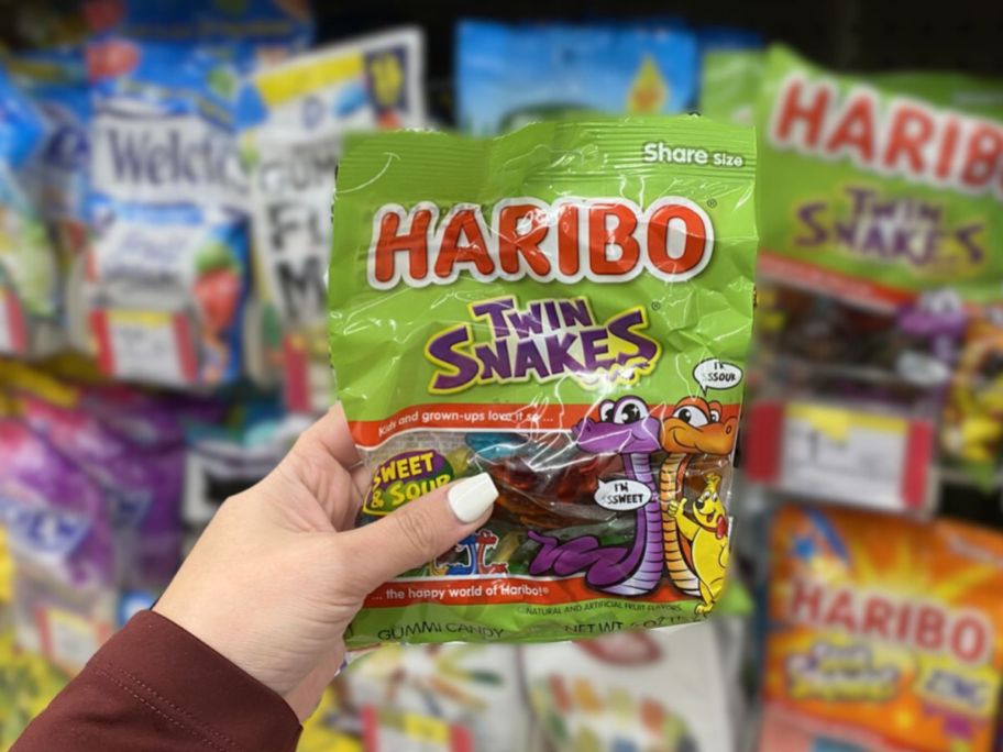 haribo snakes candy being held by hand in store