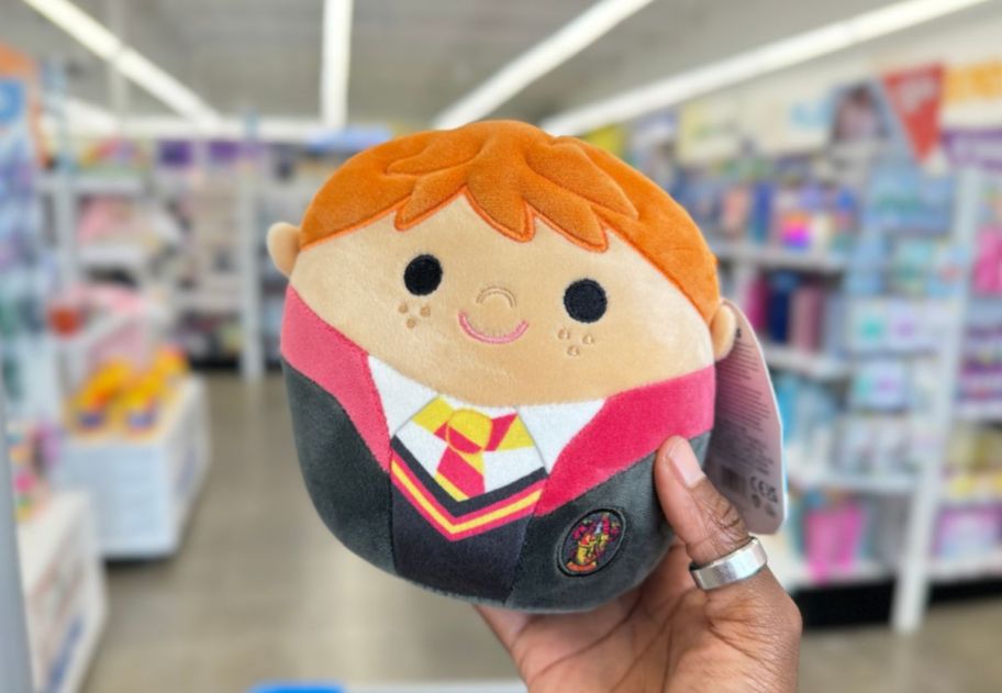 a womans hand displaying a harry potter squishmallow