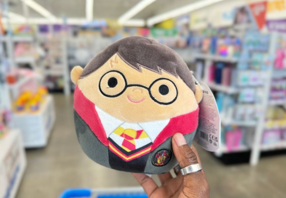 a womans hand displaying a harry potter squishmallow