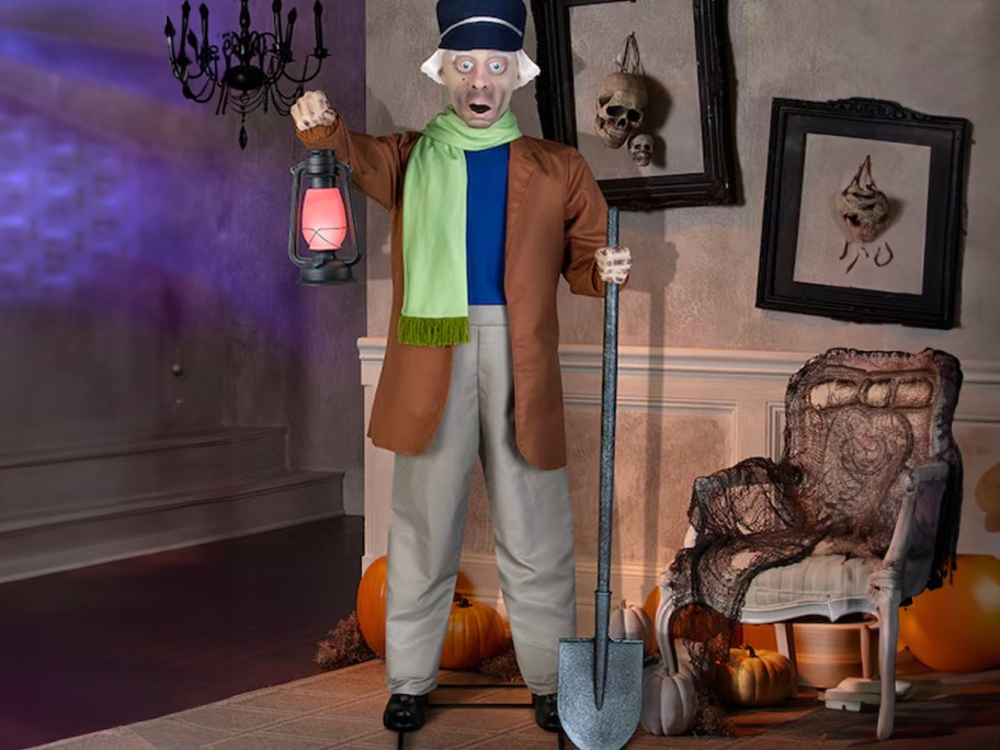caretaker animatronic holding lantern in haunted house 