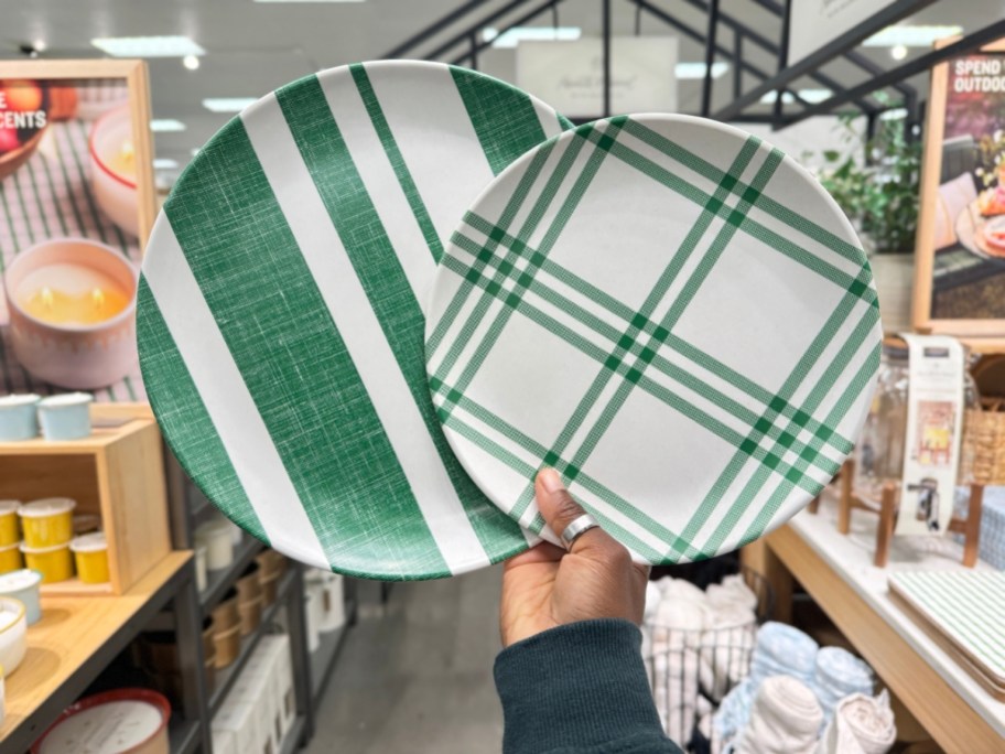 hand holding green plaid and stripe melamine plates