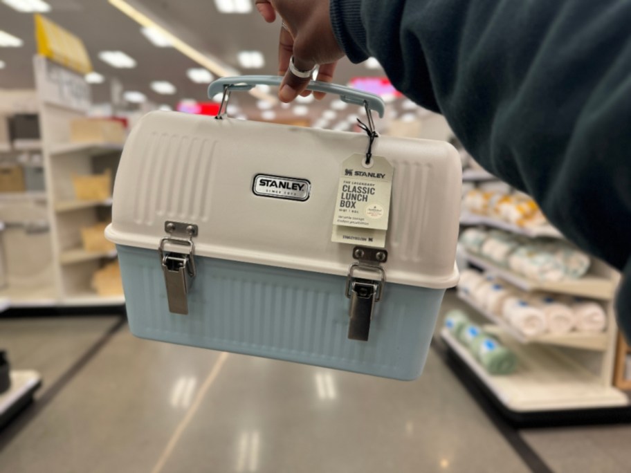 hand holding a white and blue Stanley Stainless Steel Lunch Box