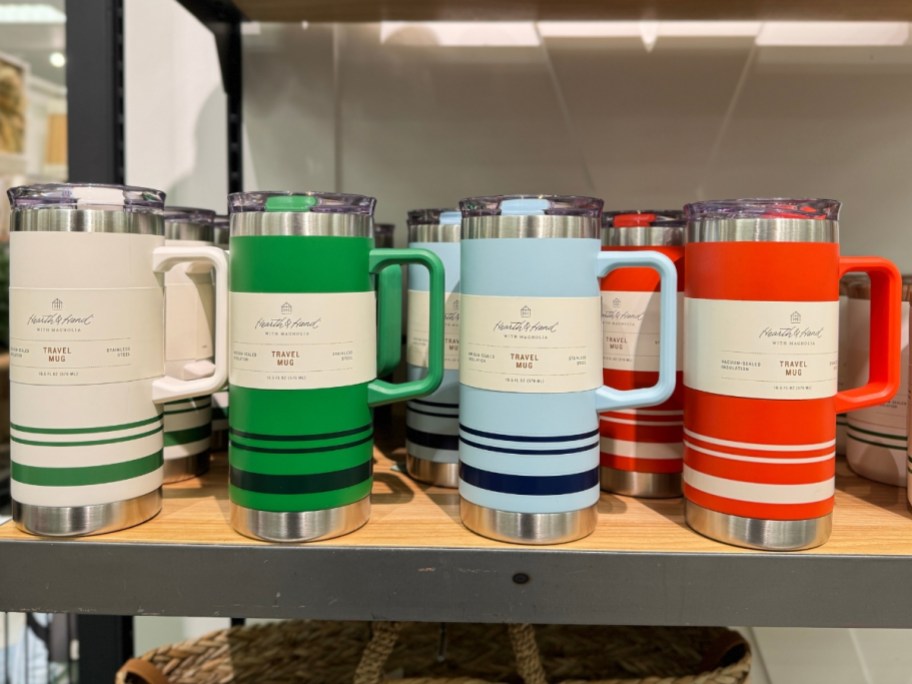travel tumblers in bright colors with handles on shelf at Target