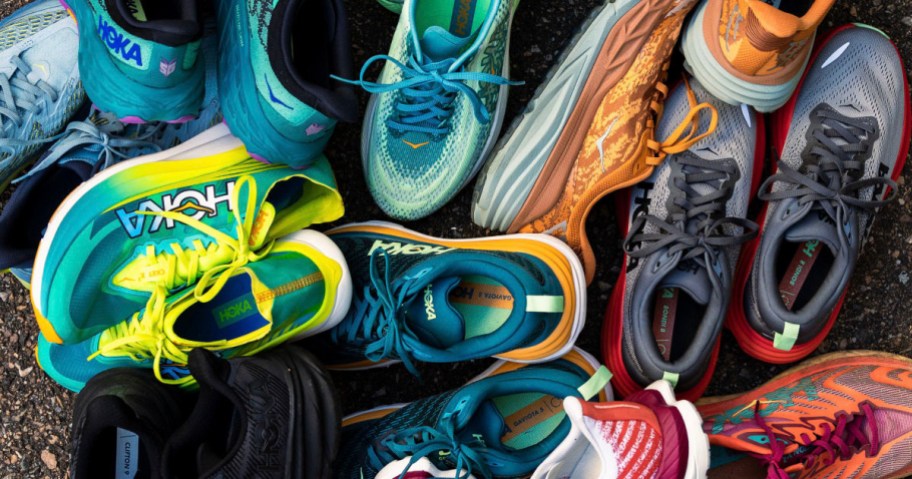 hoka running shoes in multiple colors stacked together in pile