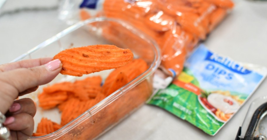 holding a seasoned raw carrot