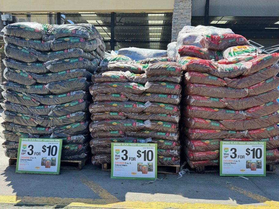 black, brown, and red mulch bags stacked at home depot