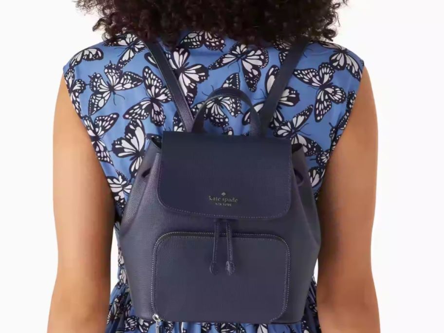 Stock image of a woman wearing a Kate Spade backpack