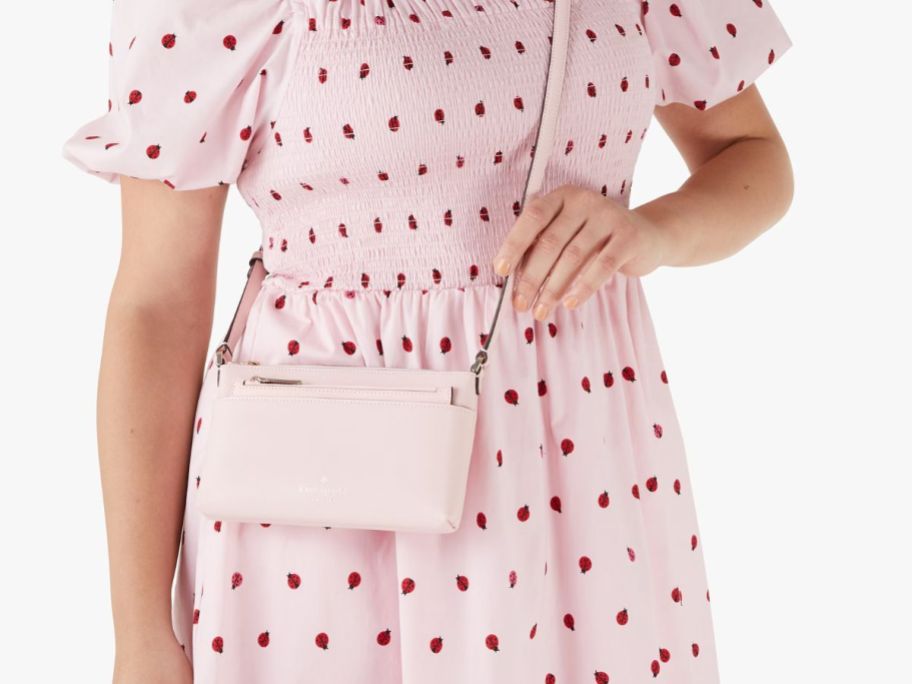 person wearing glady bug pink dress and pink crossbody bag
