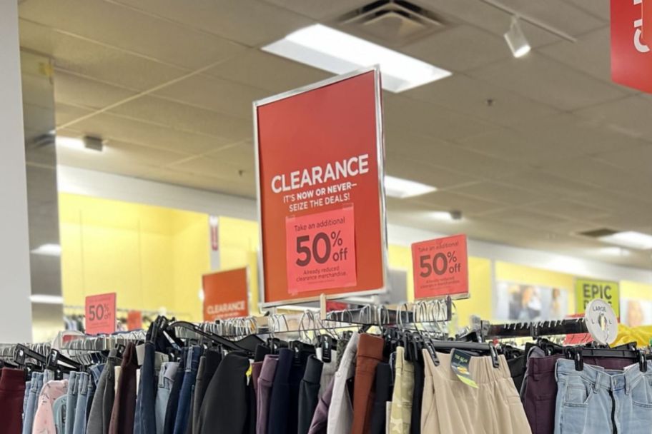 a red additional 50% off sign in the womens clothing department at a Kohl's store