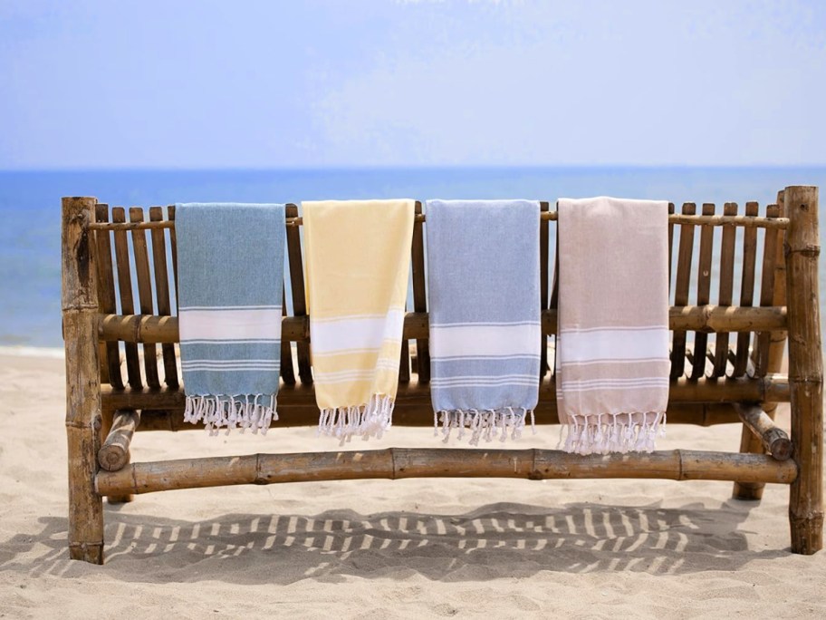 lane linen beach towels draped over a bench at the beach