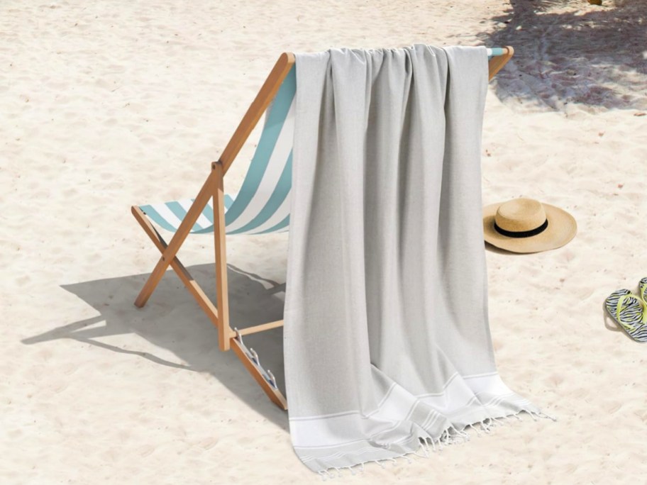 gray lane linen towel draped over the back of a beach chair