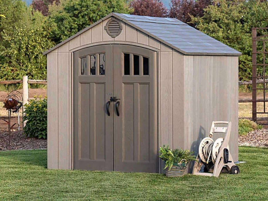 tan and brown storage shed in backyard