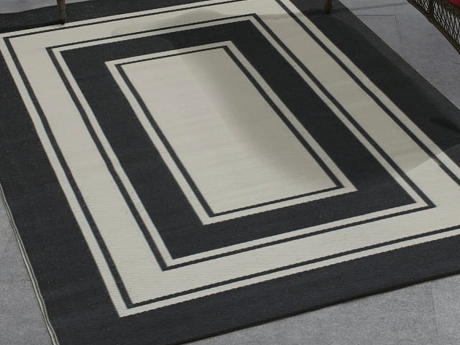 black and white area rug laying outdoors