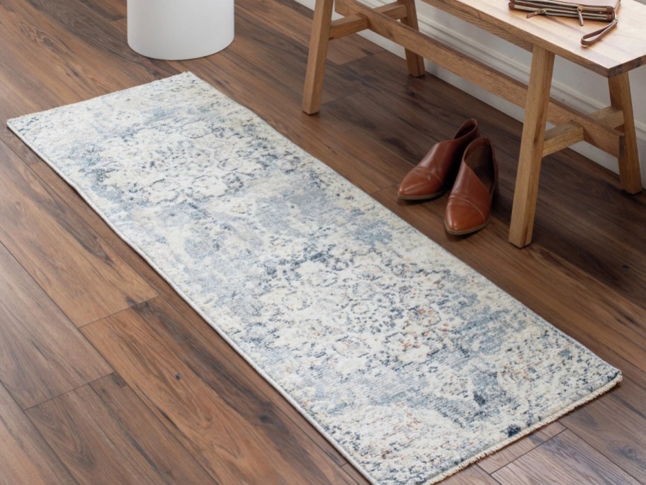 light patterned runner rug on wooden floor