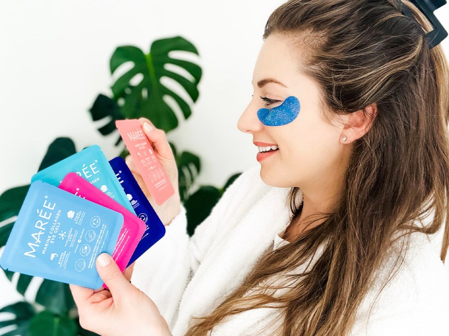 woman holding and looking at packs of maree eye gels 