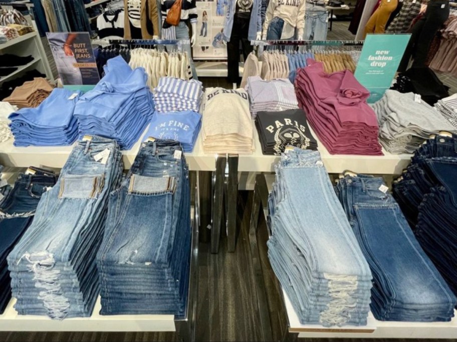 jeans and tees on display table in store