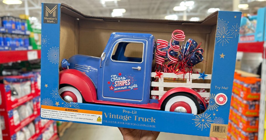 hand holding blue and red fireworks vintage truck