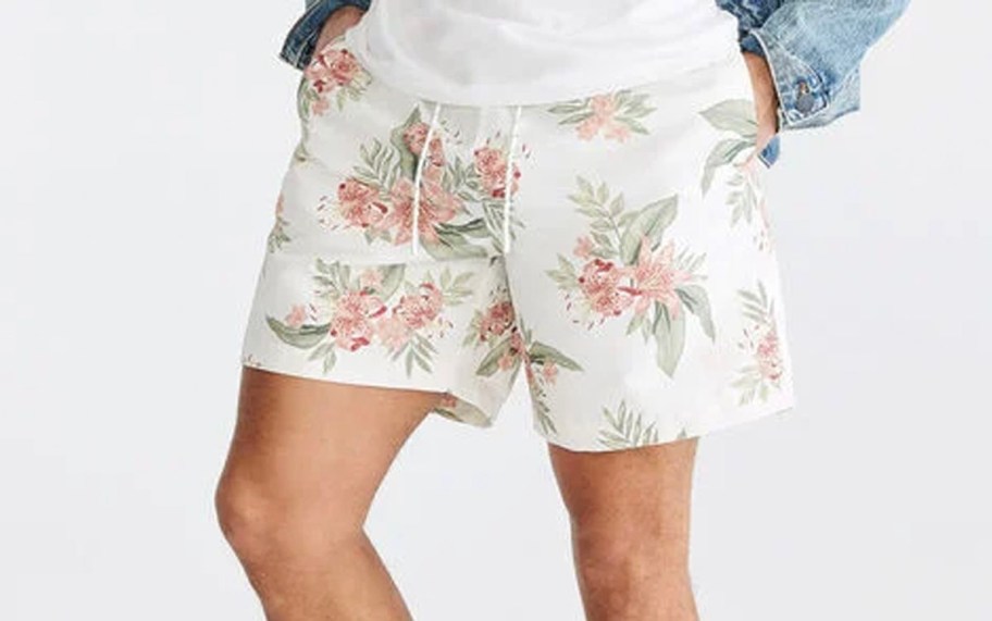 man wearing white floral shorts