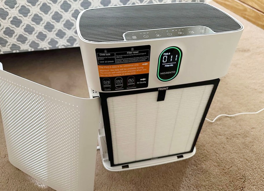 white morento air purifier with lid off sitting on carpet