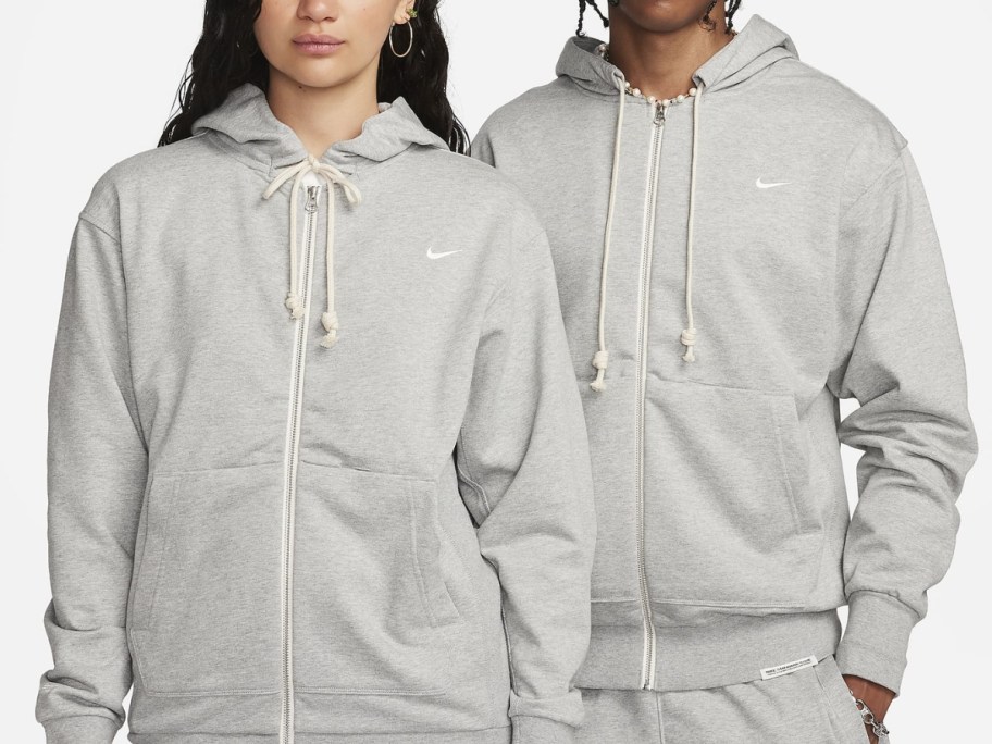 woman and man wearing grey zip up Nike hoodies