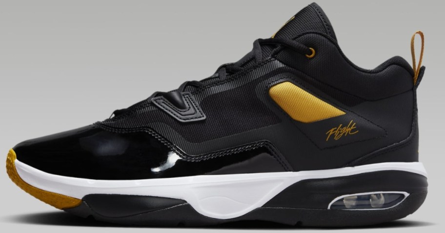 black, gold and white men's Nike Jordan shoe