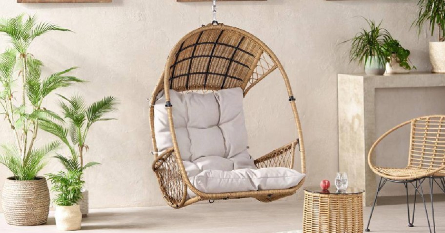 rattan egg chair swing with white cushions
