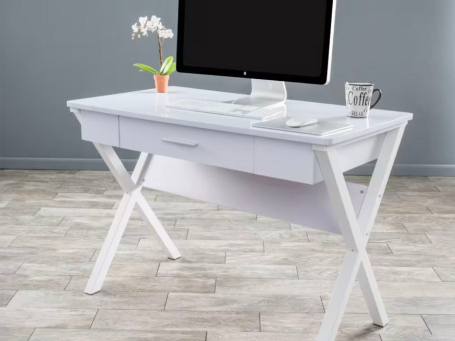 wooden white desk with imac on top and vase