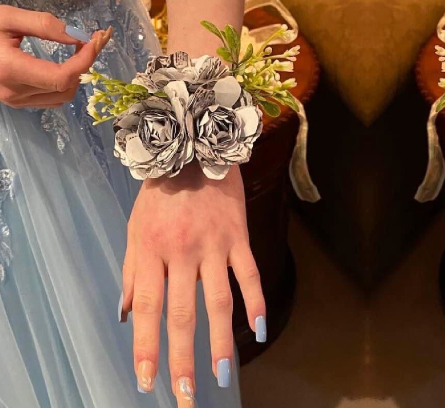 hand with paper corsage