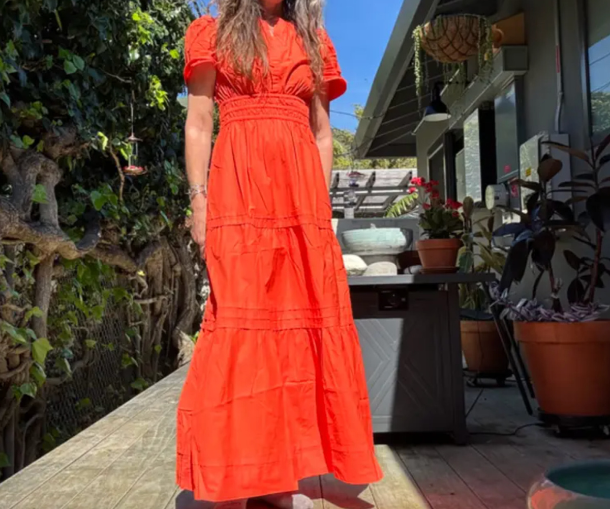 woman outside in orange maxi dress