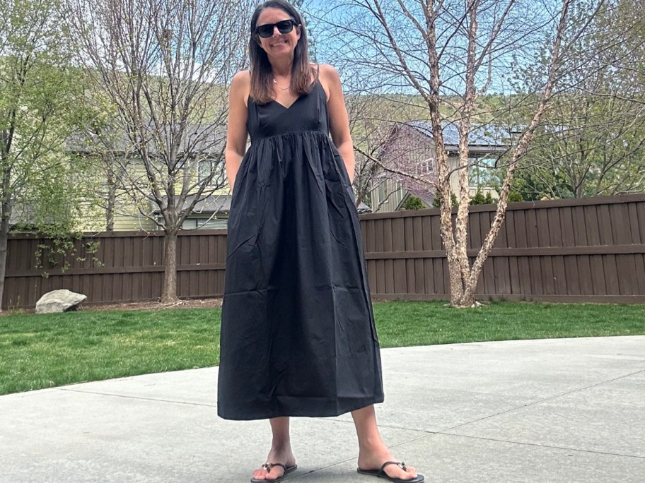 woman outside wearing black long maxi dress and sunglasses