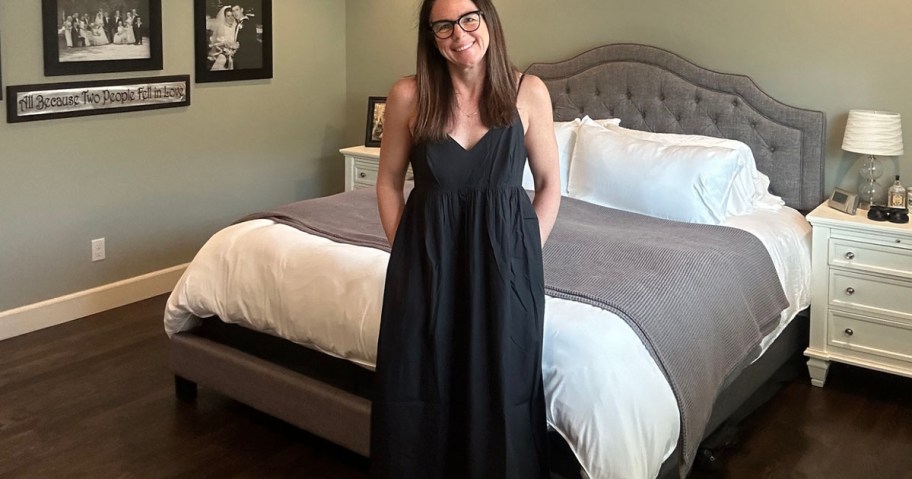 woman wearing black maxi dress in bedroom