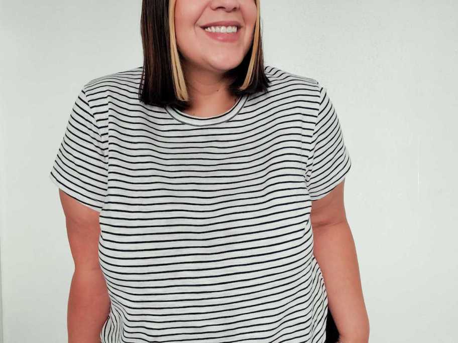 close up of woman modeling black and white stripe tshirt