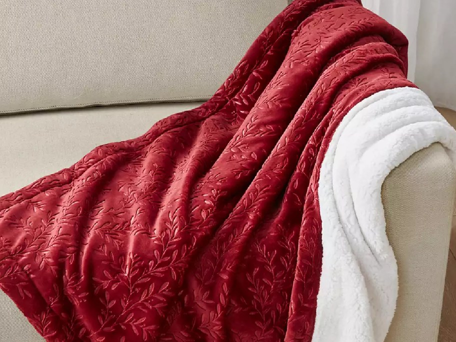red reversible blanket laidout on the couch