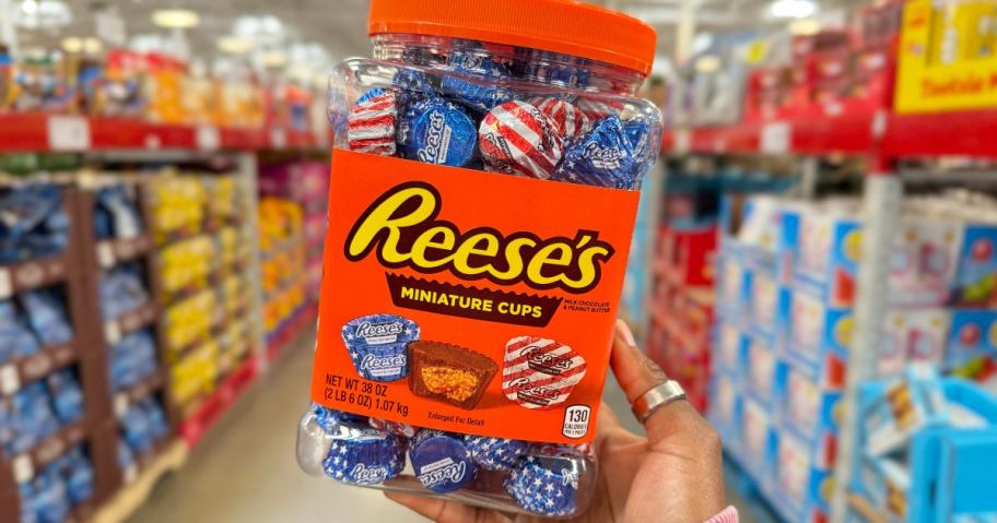 Reese's Red, White, and Blue Miniatures Peanut Butter Cups 38oz Jar being held by hand in store