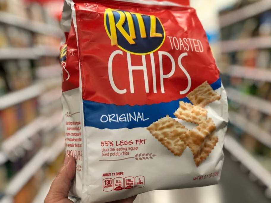 holding a bag of ritz toasted chips
