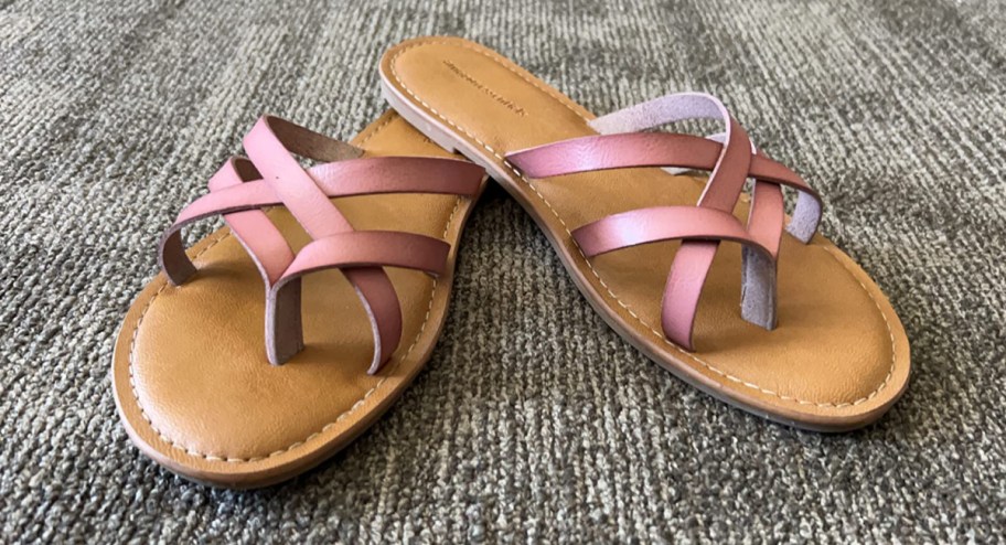 sandals displayed on carpet in a pink color