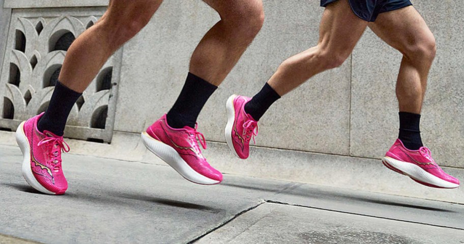 man and woman running in pink saucony shoes